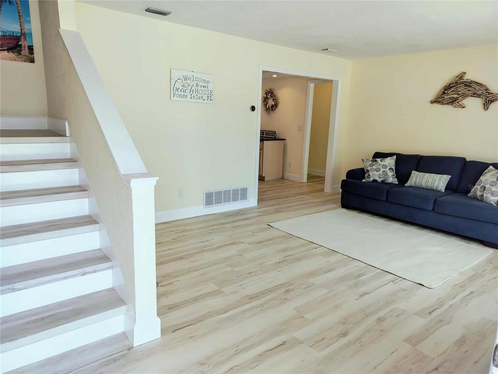 4766 South Atlantic Avenue Ponce Inlet, FL 32127 - Photo 8 of 32 a living room with furniture and a stair