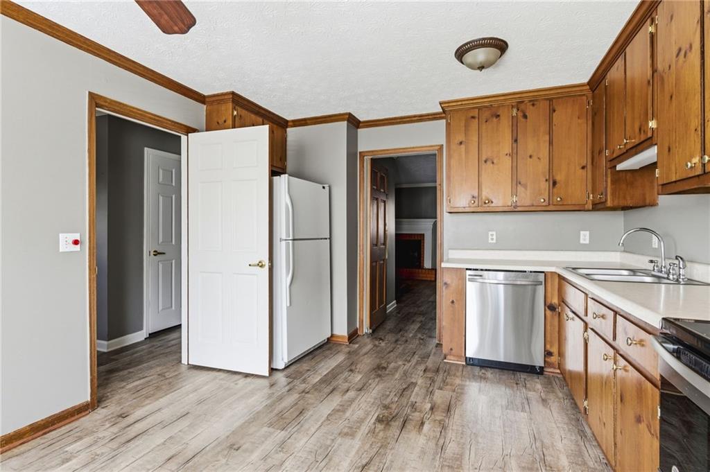 805 Manning Way Southwest Marietta, GA 30064 - Photo 13 of 27 a kitchen with stainless steel appliances granite countertop a refrigerator a sink and wooden cabinets