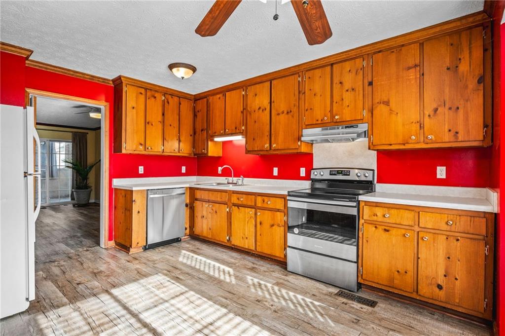 805 Manning Way Southwest Marietta, GA 30064 - Photo 14 of 35 a kitchen with stainless steel appliances granite countertop a stove a sink and a microwave