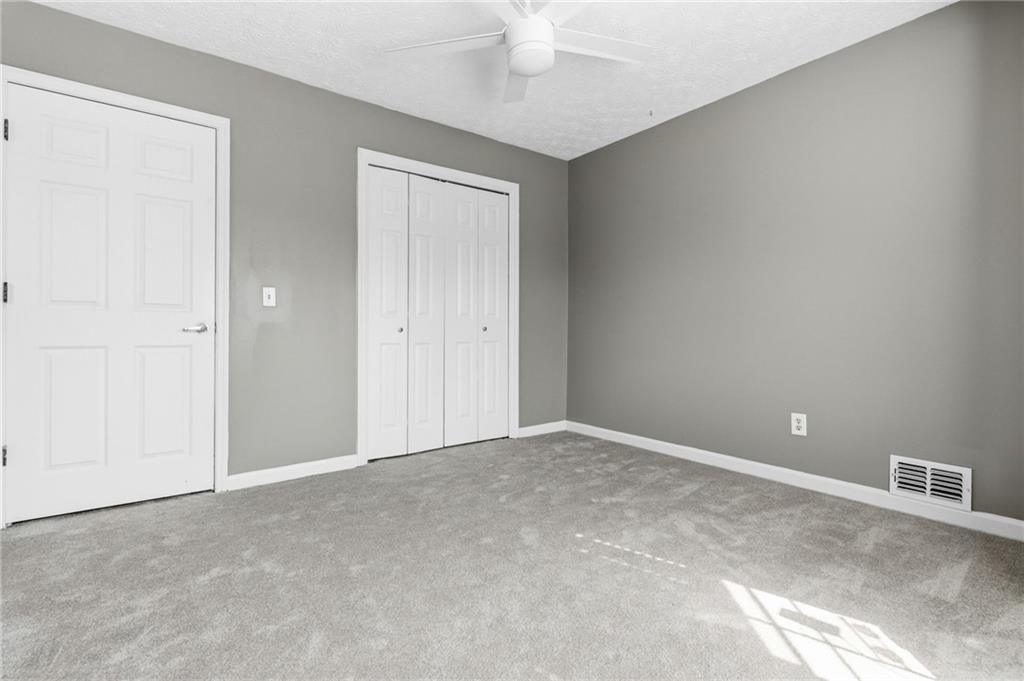 805 Manning Way Southwest Marietta, GA 30064 - Photo 15 of 27 an empty room with a ceiling fan