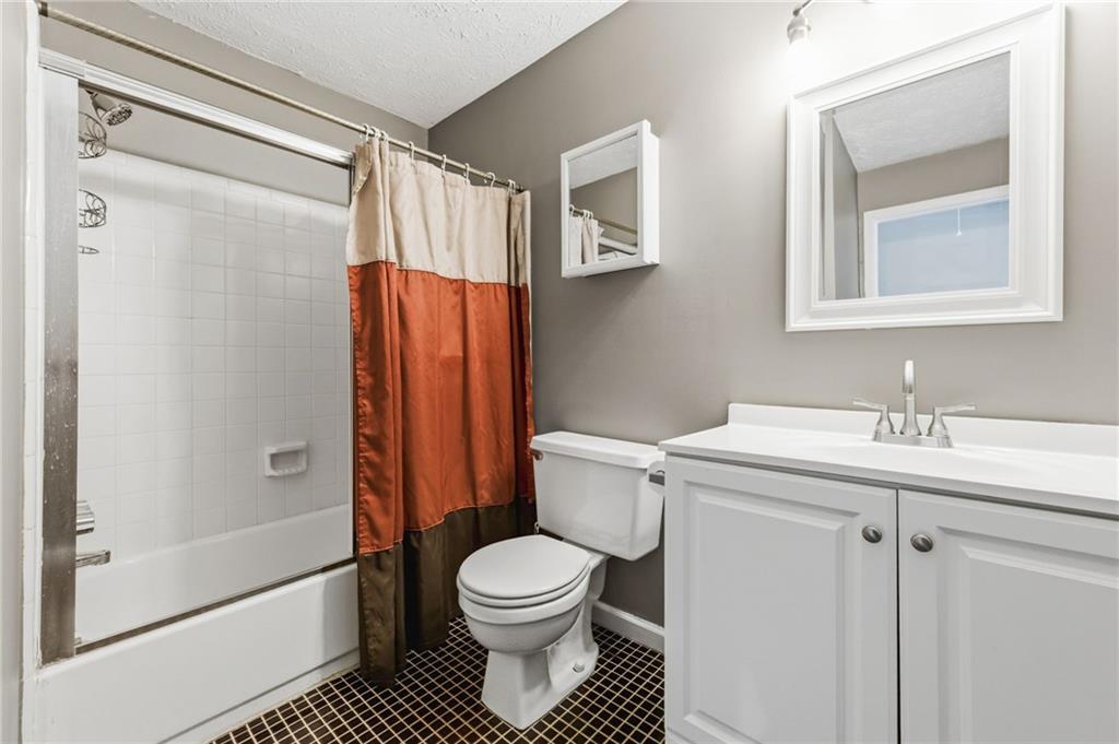 805 Manning Way Southwest Marietta, GA 30064 - Photo 17 of 27 a bathroom with a granite countertop sink toilet and shower