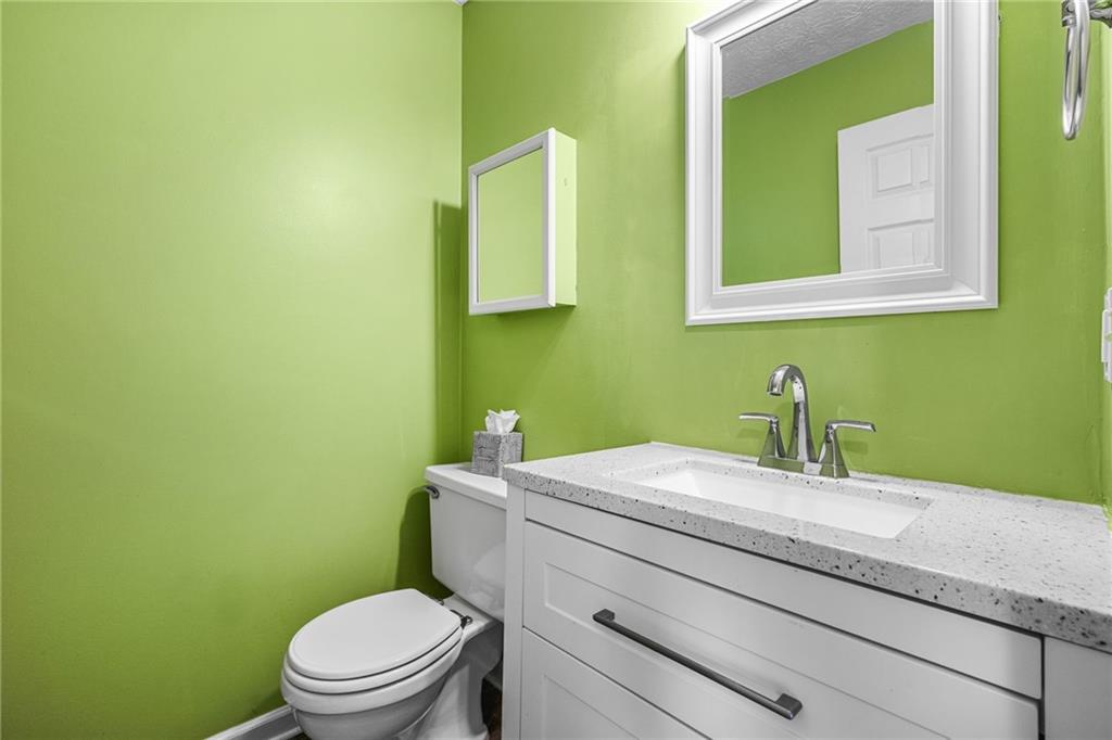 805 Manning Way Southwest Marietta, GA 30064 - Photo 19 of 35 a bathroom with a granite countertop toilet sink and mirror