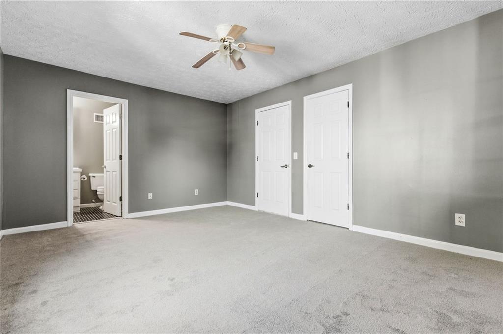 805 Manning Way Southwest Marietta, GA 30064 - Photo 19 of 27 an empty room with fan and a hallway