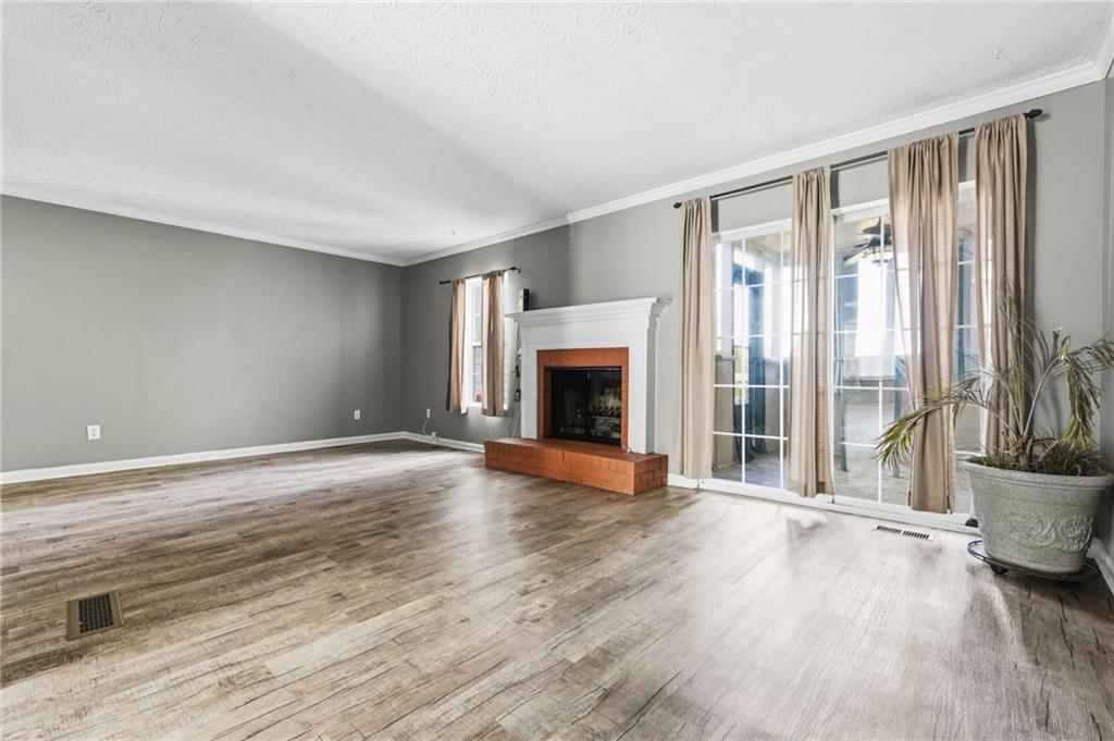 805 Manning Way Southwest Marietta, GA 30064 - Photo 2 of 27 wooden floor fireplace and windows in an empty room