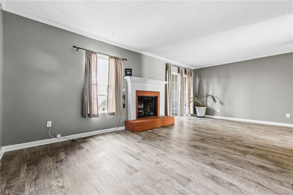 805 Manning Way Southwest Marietta, GA 30064 - Photo 3 of 27 wooden floor fireplace and windows in an empty room