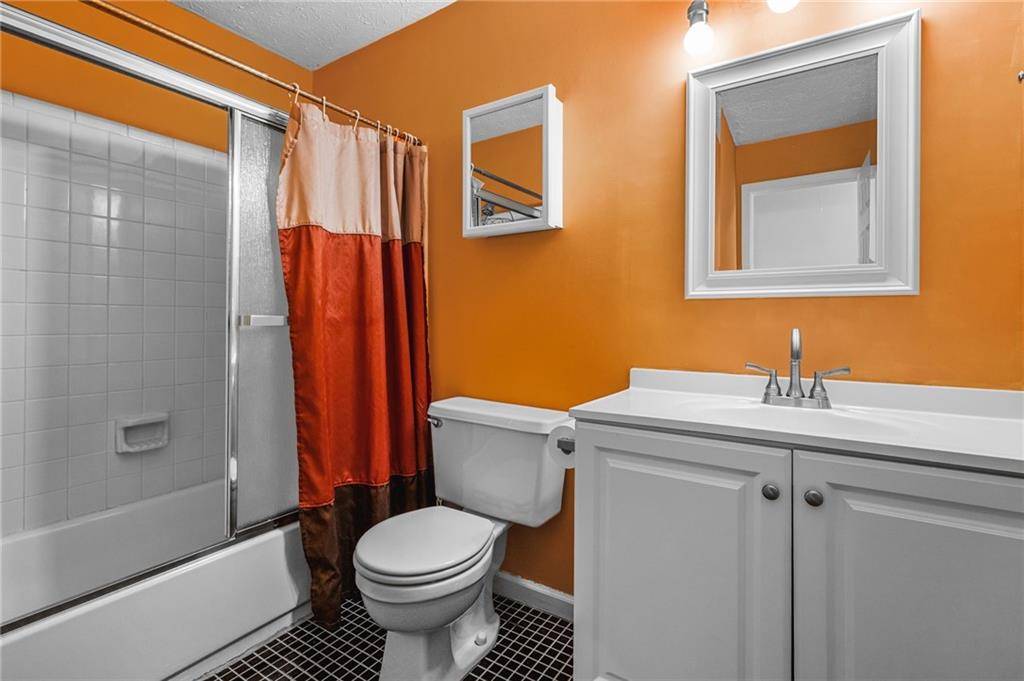 805 Manning Way Southwest Marietta, GA 30064 - Photo 34 of 35 a bathroom with a sink a toilet and shower