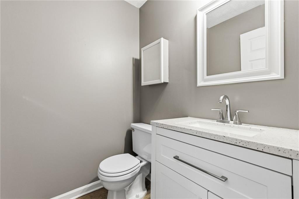 805 Manning Way Southwest Marietta, GA 30064 - Photo 5 of 27 a bathroom with a granite countertop toilet and a sink