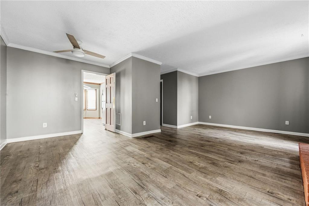 805 Manning Way Southwest Marietta, GA 30064 - Photo 7 of 27 a view of an empty room with wooden floor and a window