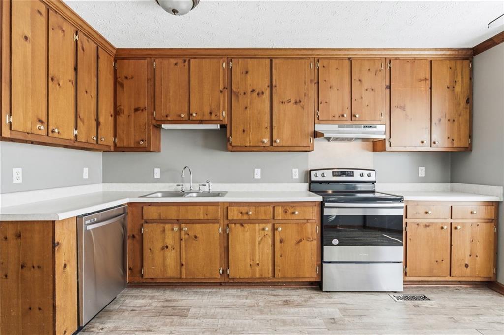 805 Manning Way Southwest Marietta, GA 30064 - Photo 10 of 27 a kitchen with stainless steel appliances granite countertop a stove and a sink