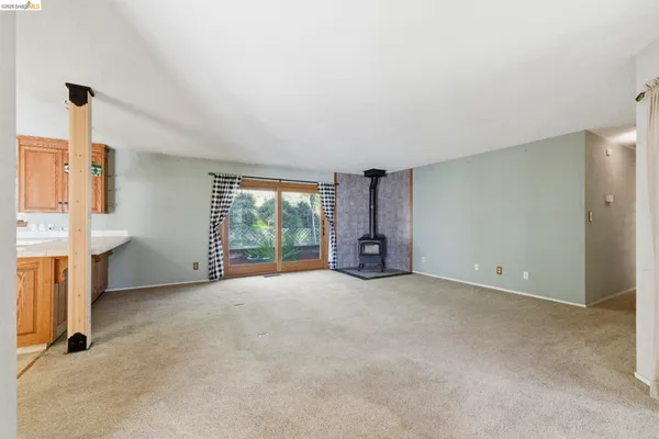 an empty room with a fireplace and window