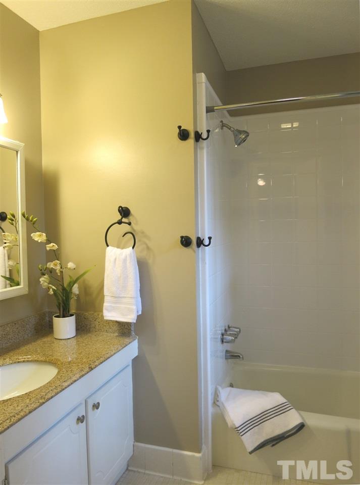 5201 Knollwood Road Raleigh, NC 27609 - Photo 17 of 25 The updated Master Bath features a tiled floor, tub/shower & mirrored medicine cabinet.