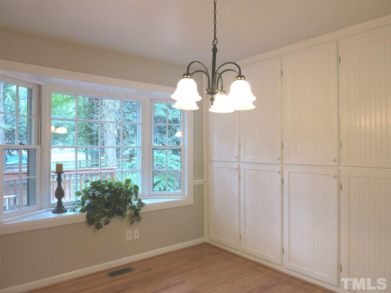 5201 Knollwood Road Raleigh, NC 27609 - Photo 7 of 25 The formal Dining Rm has chair rail molding, a wall of floor-to-ceiling cabinets & a bay window w/window seat.