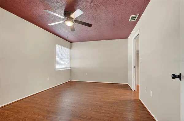 wooden floor in an empty room with a window