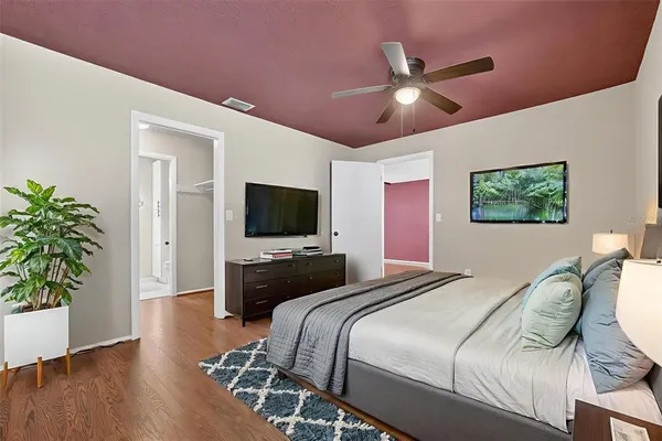 a bedroom with a bed and a flat screen tv