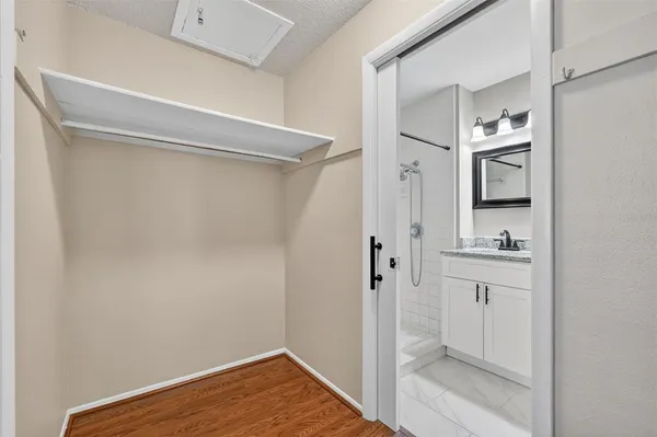 a bathroom with a shower and a sink
