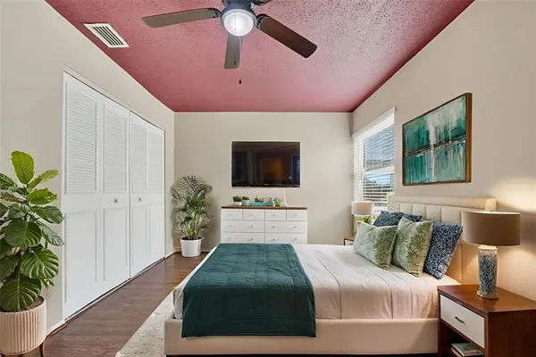 a bedroom with a bed and a flat screen tv