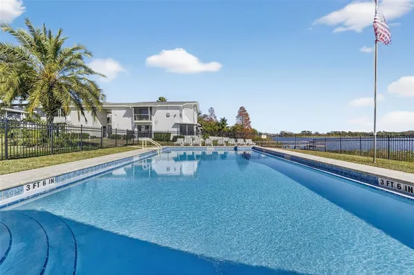 a living room with furniture and a large pool