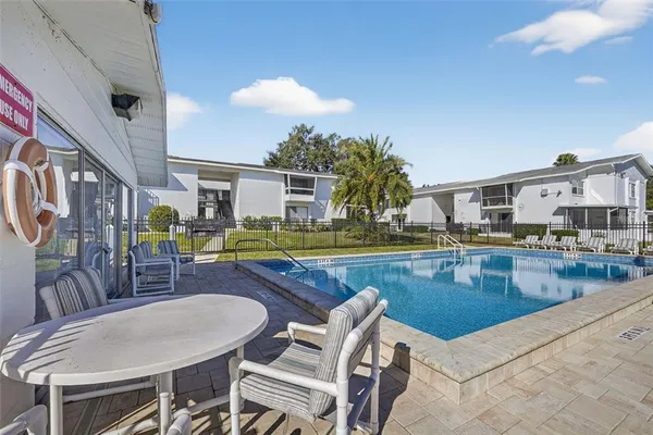 a view of a house with swimming pool and sitting area