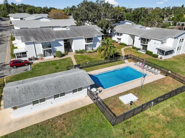 a view of a patio with chairs and a table