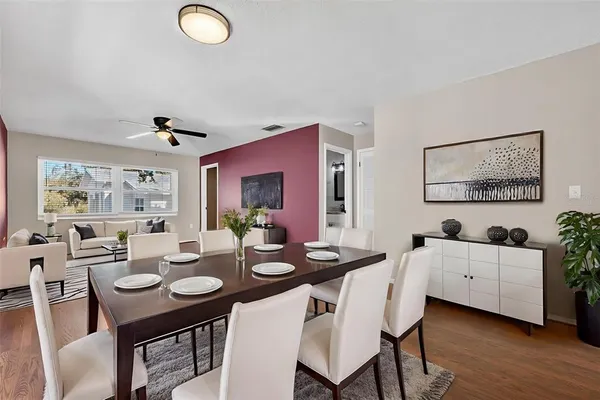 a view of a dining room with furniture and wooden floor