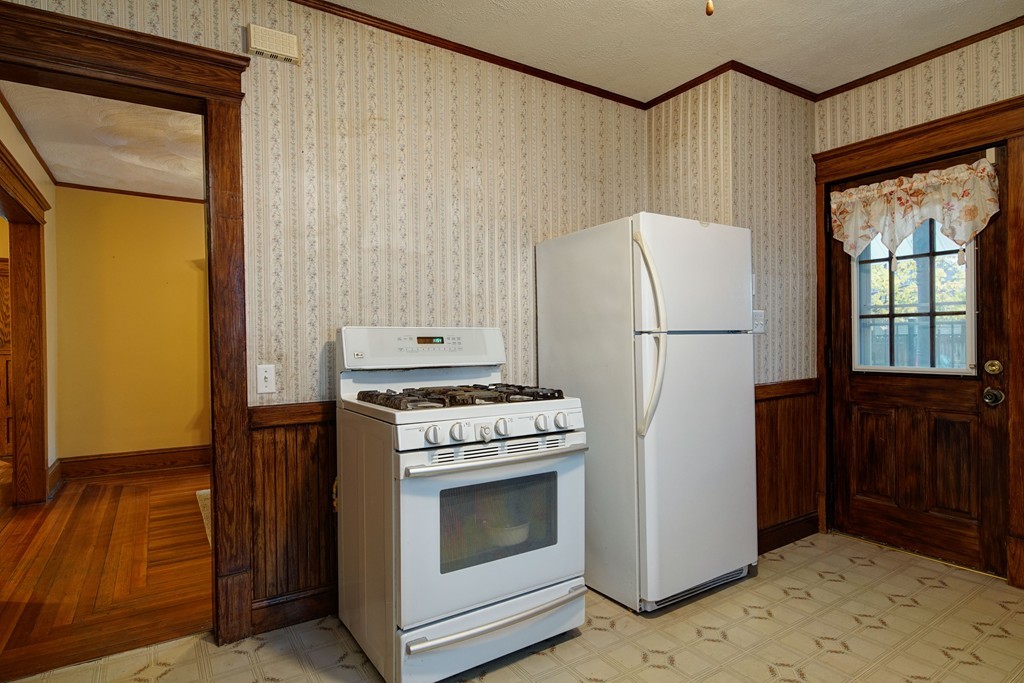 86 Osborne Terrace Springfield, MA 01104 - Photo 14 of 30 a kitchen with a stove a refrigerator and a cabinets