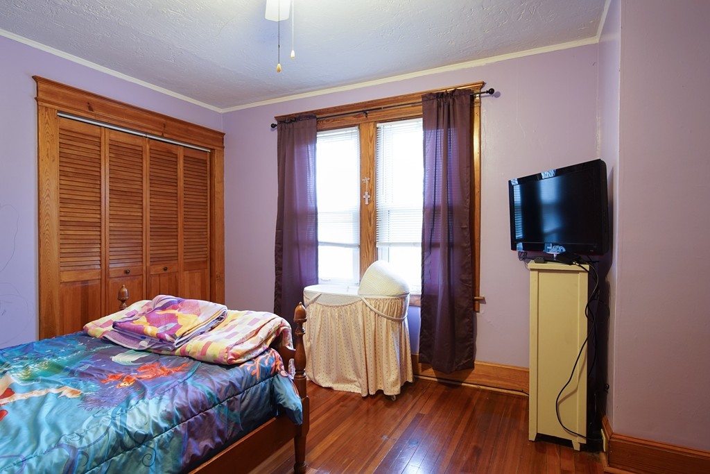 86 Osborne Terrace Springfield, MA 01104 - Photo 21 of 30 a bedroom with a bed and wooden floor