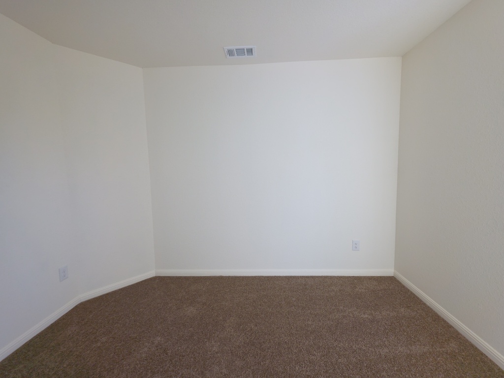 2002 West 2nd Street, Unit 100 Taylor, TX 76574 - Photo 11 of 16 Spare room with dark colored carpet and baseboards