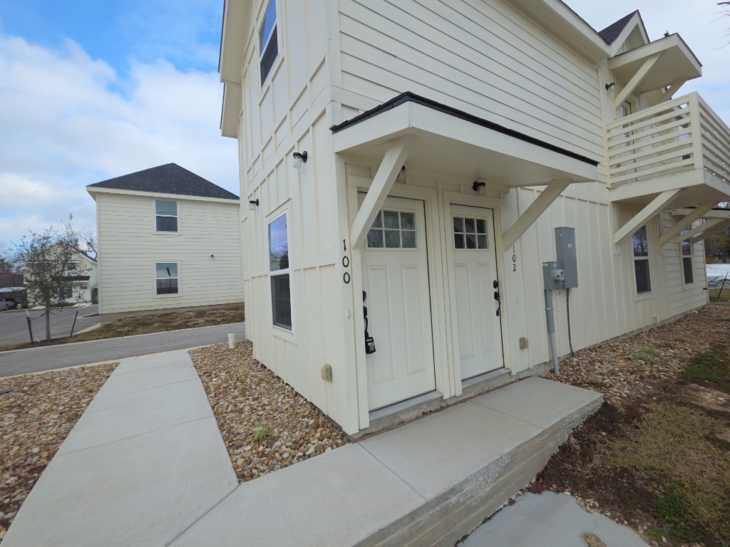2002 West 2nd Street, Unit 100 Taylor, TX 76574 - Photo 2 of 16 Doorway to property with board and batten siding