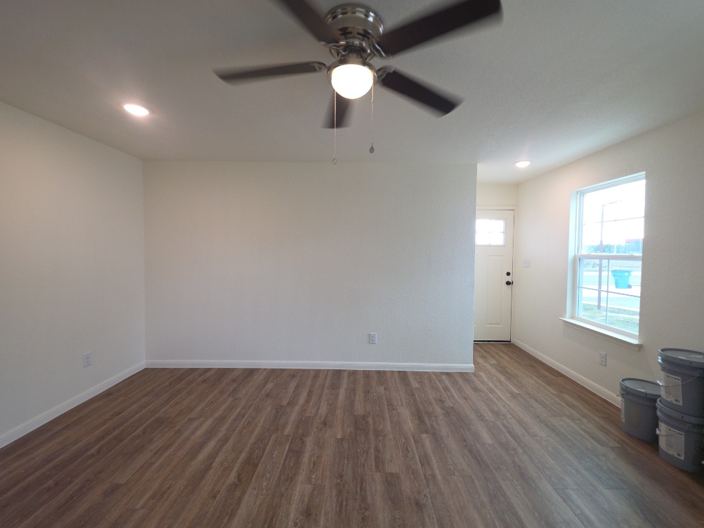 2002 West 2nd Street, Unit 100 Taylor, TX 76574 - Photo 4 of 16 Empty room with recessed lighting, dark wood-style floors, and a ceiling fan