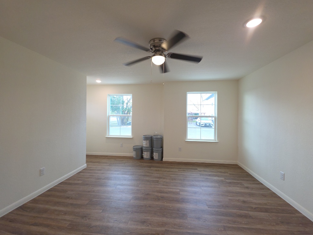 2002 West 2nd Street, Unit 100 Taylor, TX 76574 - Photo 5 of 16 Unfurnished room with dark wood-style flooring, recessed lighting, and ceiling fan