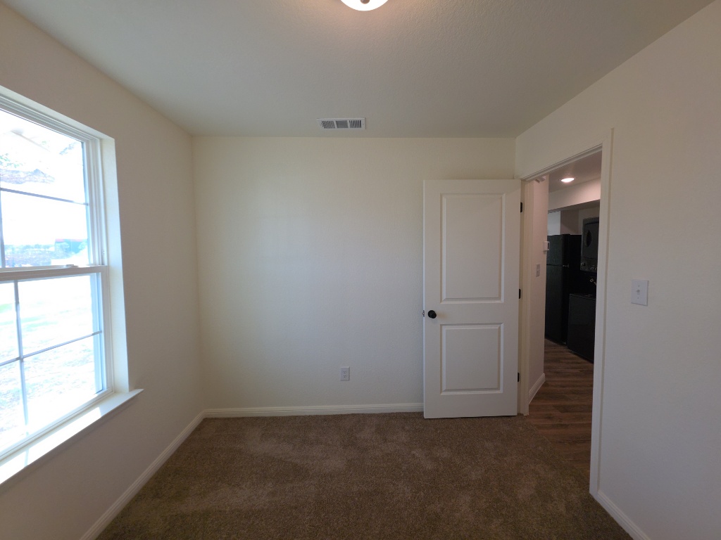 2002 West 2nd Street, Unit 100 Taylor, TX 76574 - Photo 10 of 16 Carpeted empty room with baseboards
