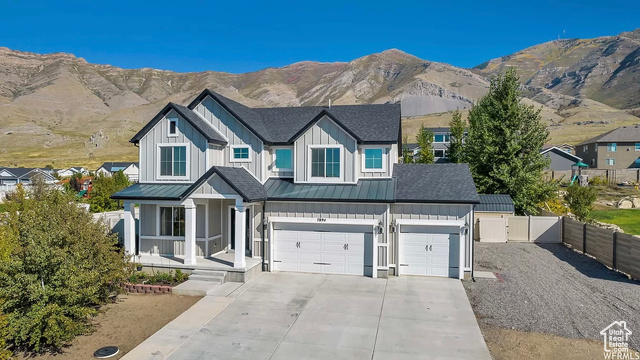 7894 North Cobblerock Road Tooele, UT 84074 - Photo 1 of 1 View of front of home with a mountain view, fence, driveway
