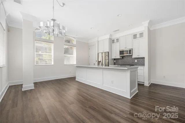 a kitchen with stainless steel appliances granite countertop a sink a microwave counter space and cabinets