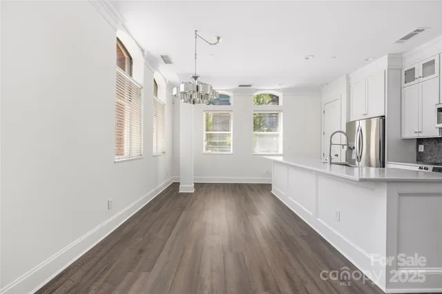 a kitchen with granite countertop a stove and wooden floor