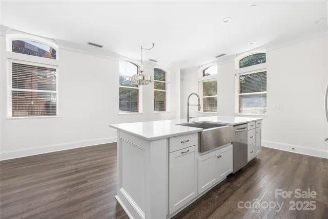 a kitchen with stainless steel appliances a sink a stove and refrigerator