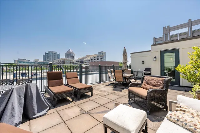 a view of a house with a big yard and large trees
