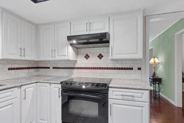 a stove top oven sitting inside of a kitchen