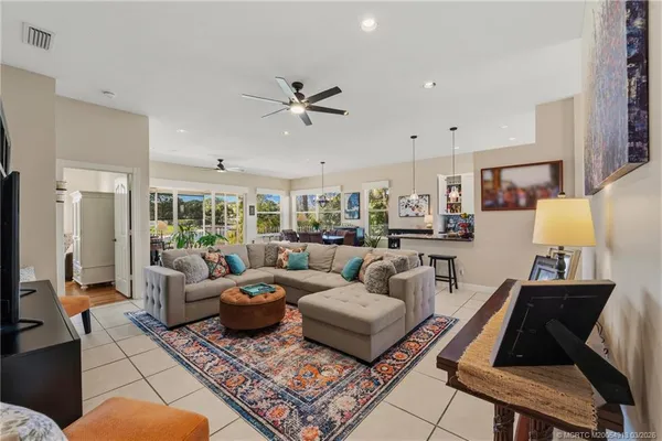 a living room with furniture a rug and a chandelier