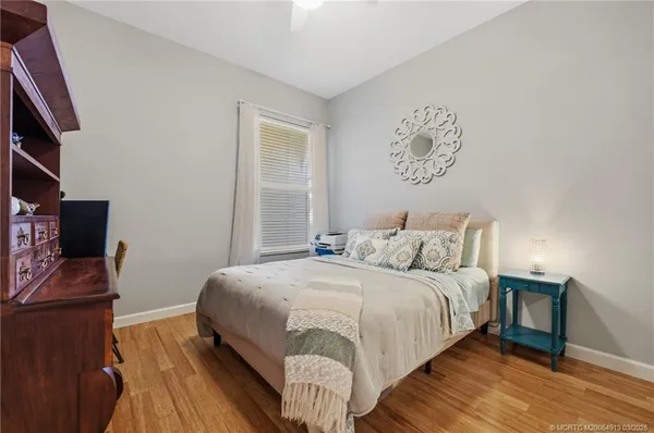 a bedroom with a bed and wooden floor