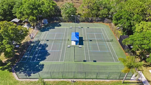 an aerial view of residential houses with outdoor space and swimming pool