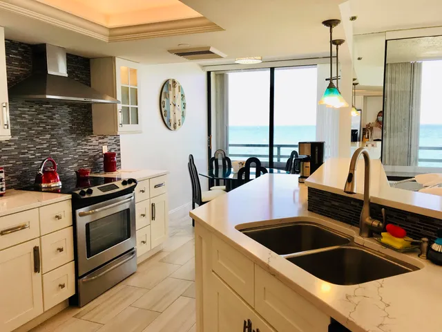 a kitchen with stainless steel appliances granite countertop a sink and a stove