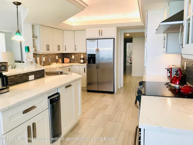 a kitchen with a sink cabinets and refrigerator