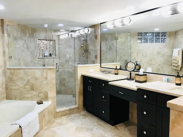 a bathroom with a double vanity sink mirror double and shower