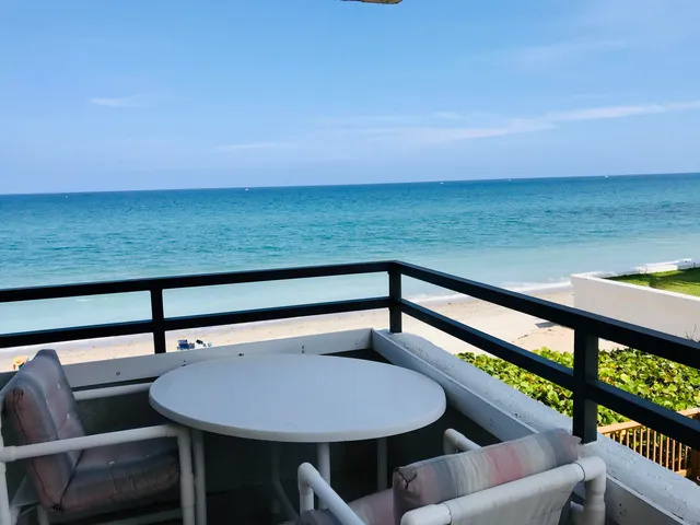 a view of a chairs and table in the balcony