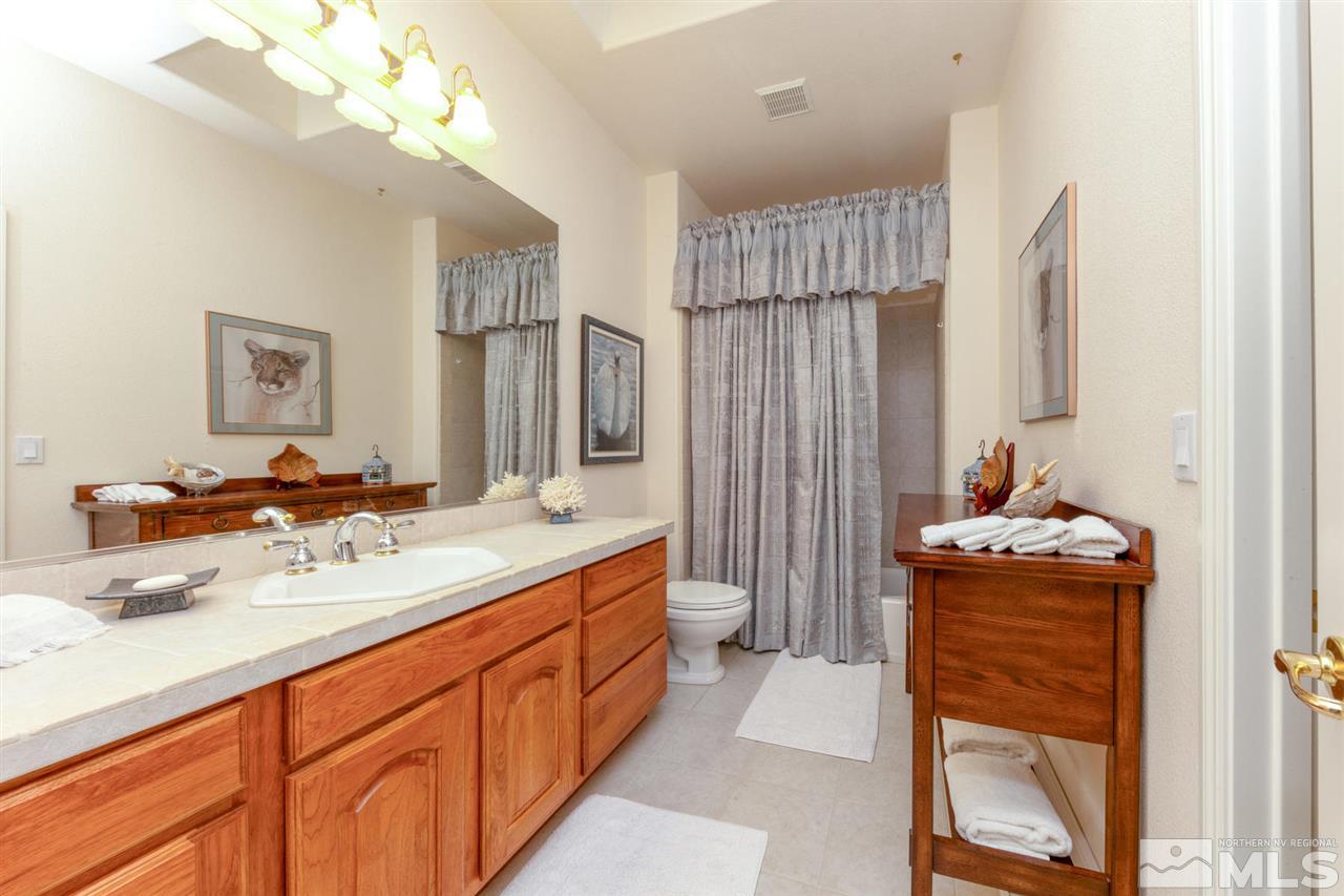 1352 Wolf Run Road Reno, NV 89511 - Photo 22 of 25 a bathroom with a sink double vanity and a mirror
