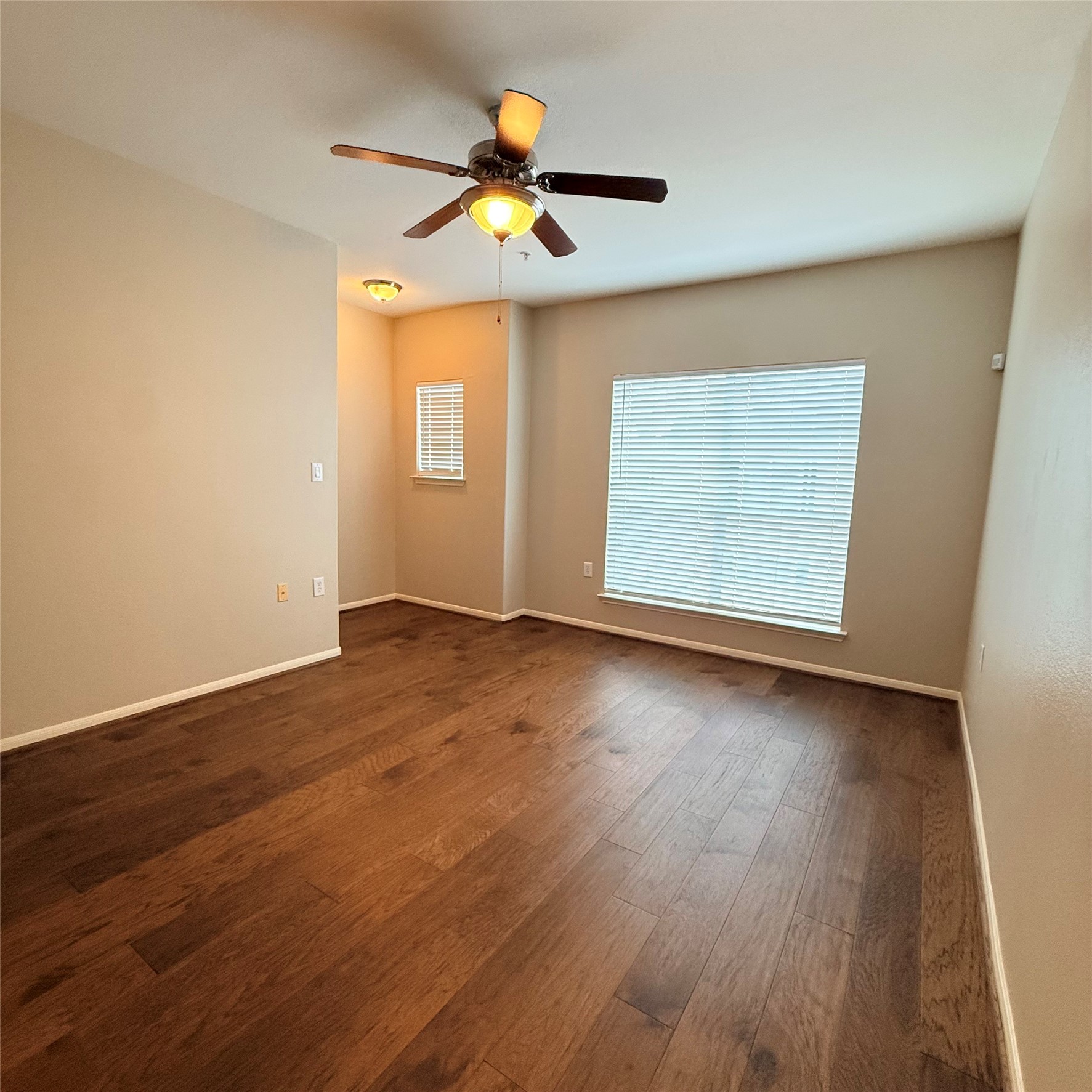 9200 Westheimer Road, Unit 304 Houston, TX 77063 - Photo 13 of 24 an empty room with wooden floor and windows