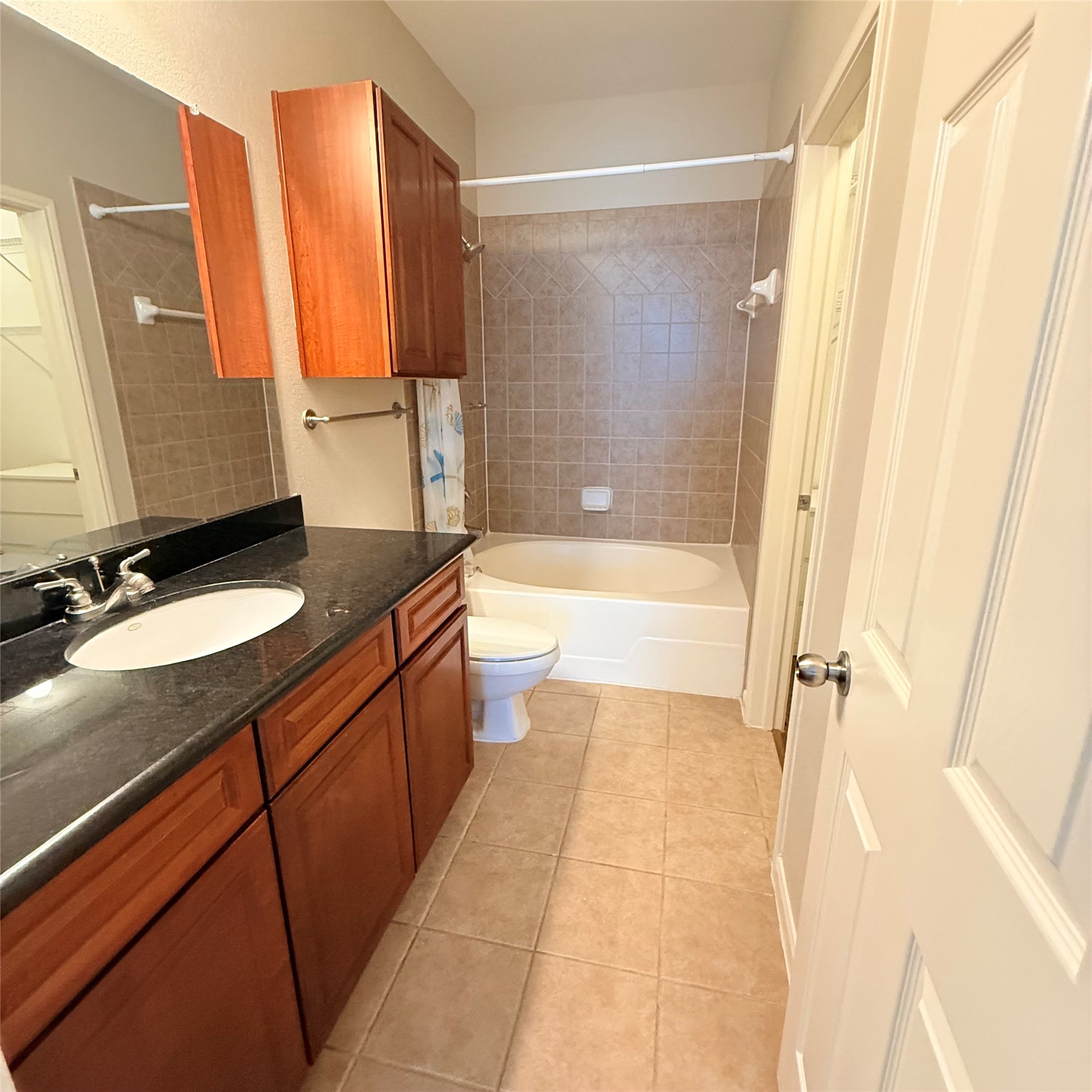 9200 Westheimer Road, Unit 304 Houston, TX 77063 - Photo 14 of 24 a bathroom with a granite countertop sink a mirror and a bathtub