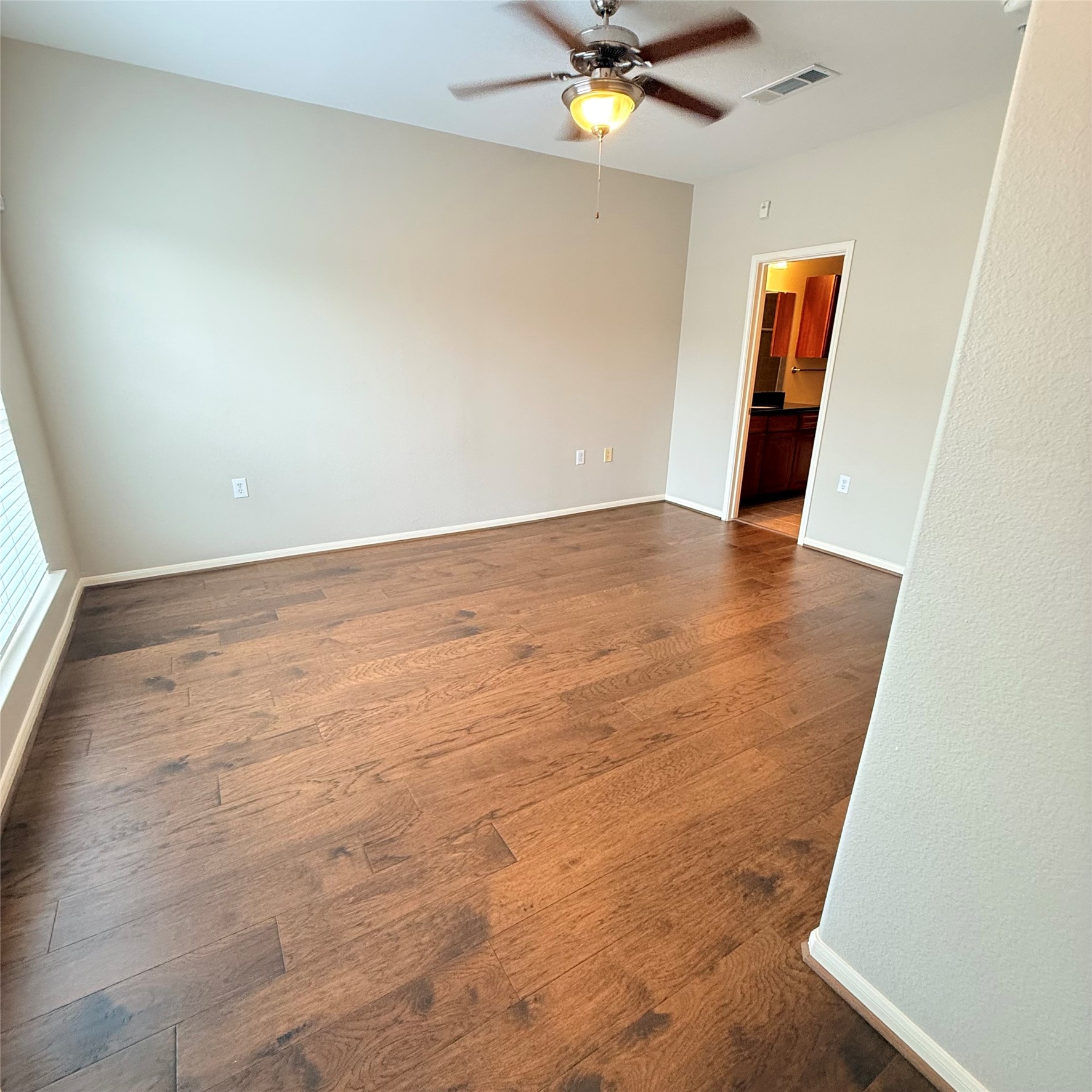 9200 Westheimer Road, Unit 304 Houston, TX 77063 - Photo 17 of 24 an empty room with wooden floor and hallway