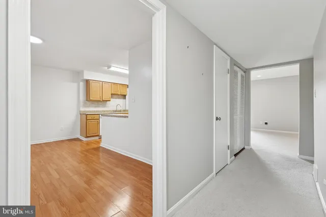 a view of a kitchen with wooden floor and a sink