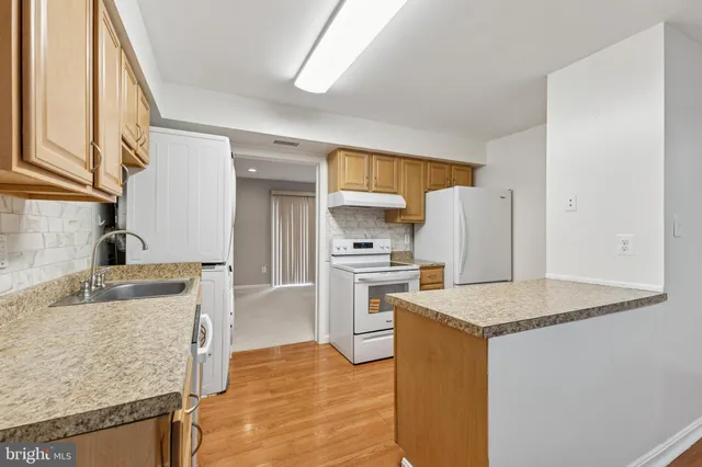 a kitchen with a stove a sink and a refrigerator
